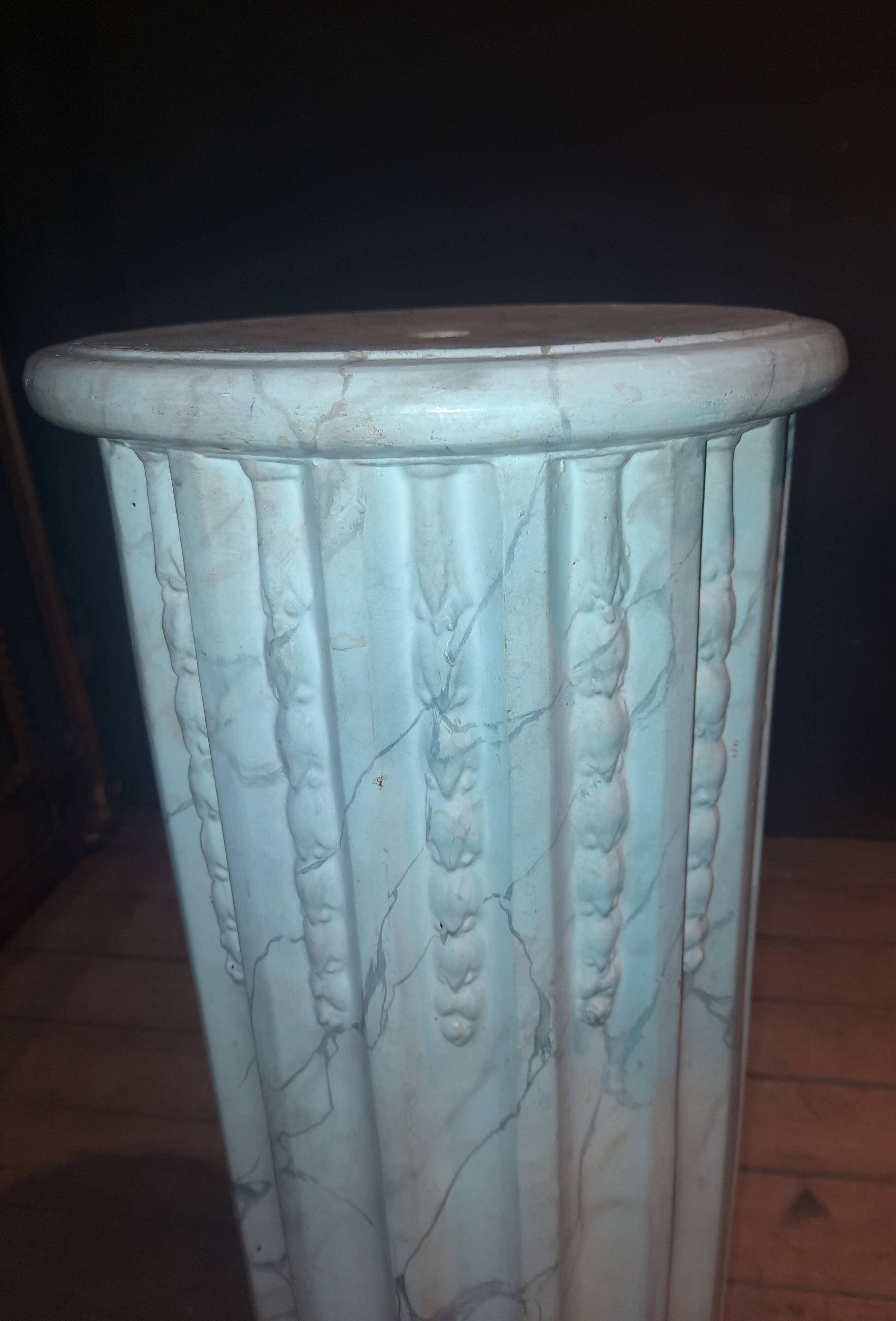 Column topped with a plaster basin.