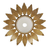 Old sun mirror with foliage in gilded metal with twisted frieze from the 60s