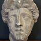 Antique plaster sculpture of a female face from the early 20th century