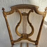 Pair of chairs with a golden lyre