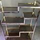 Italian shelf in gold-plated metal and smoked glass