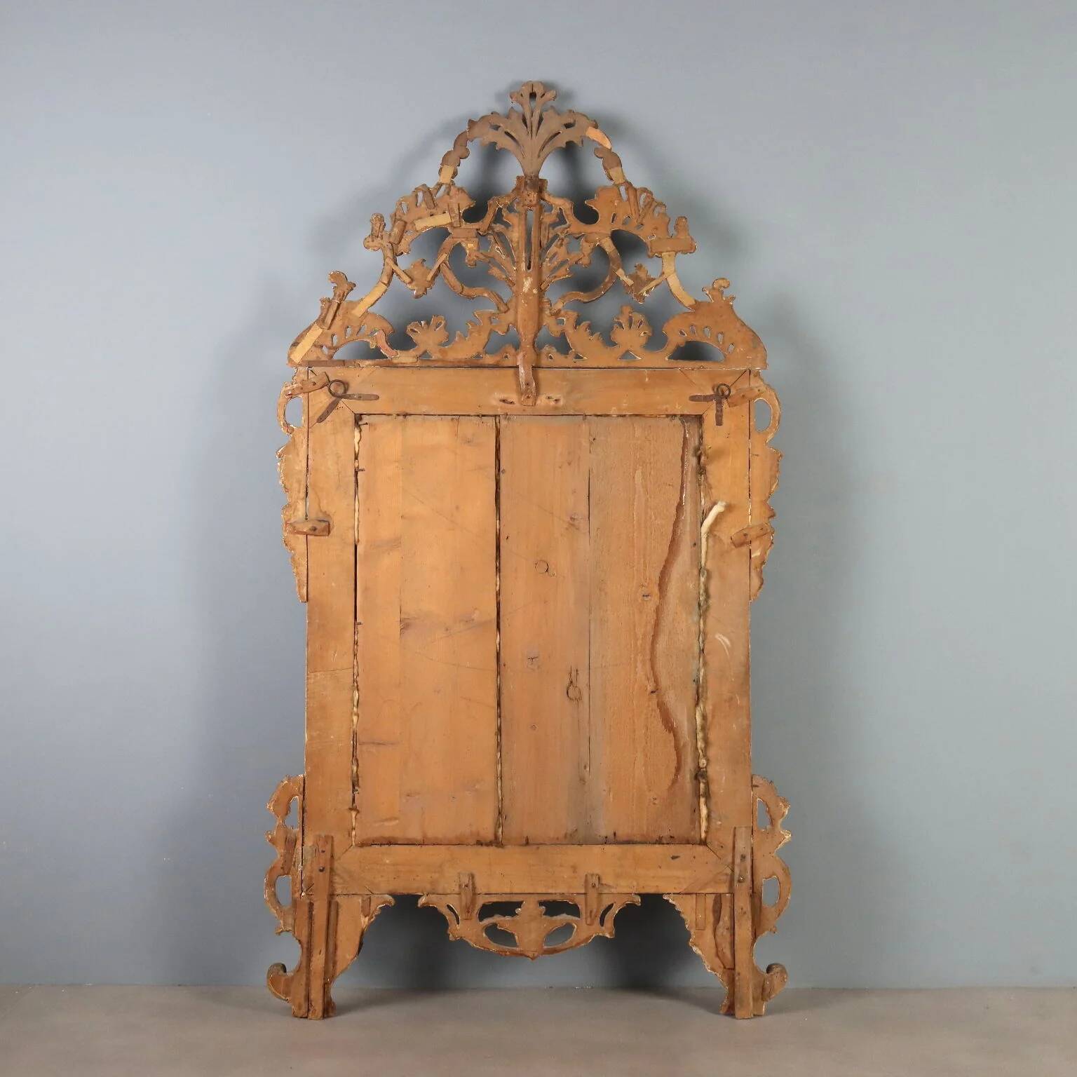 Antique gilded wooden mirror with rococo patterns, Italy, 18th century.