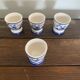 Set of 4 antique delft egg cups, white ceramic with blue vinta decor