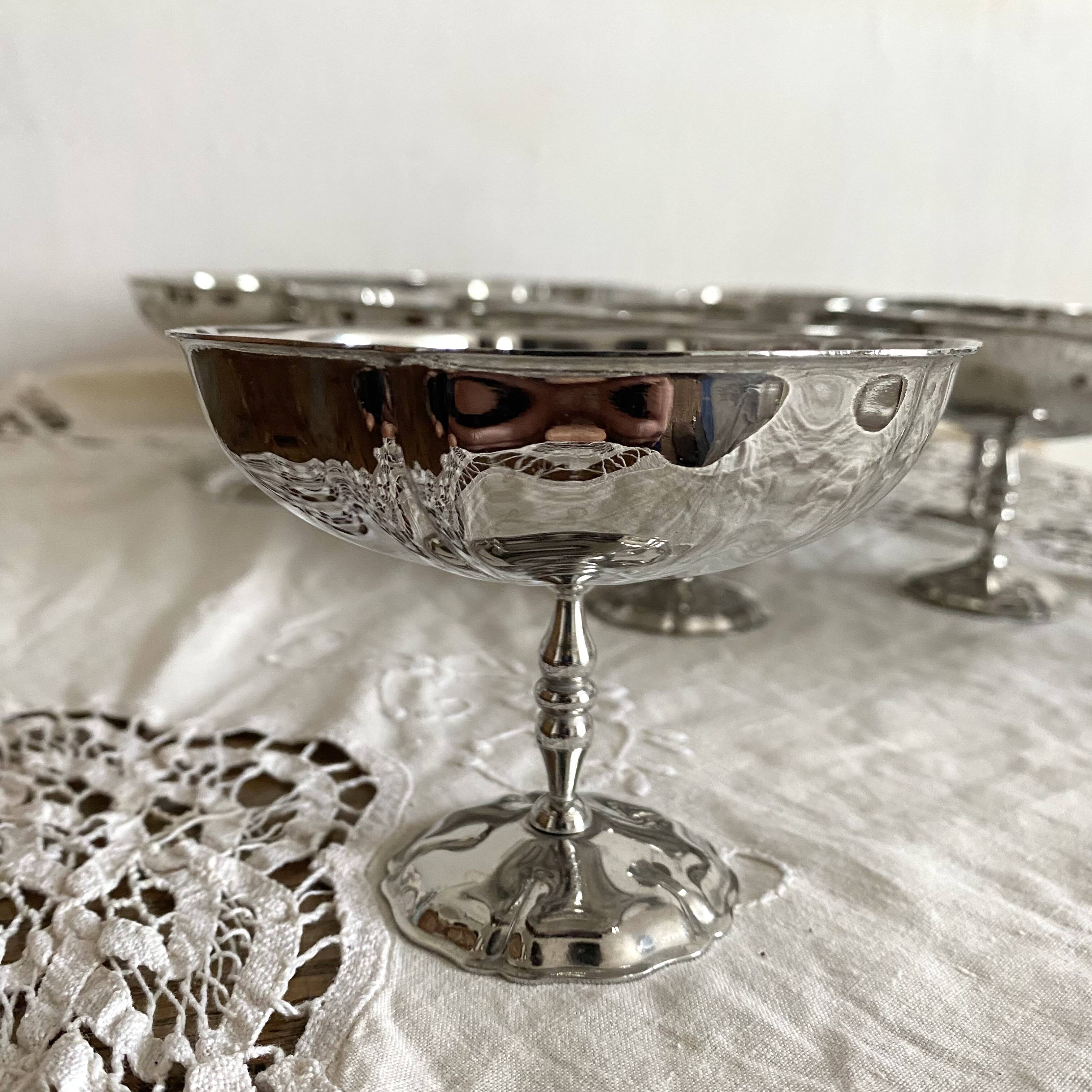 Vintage stainless steel cups on foot