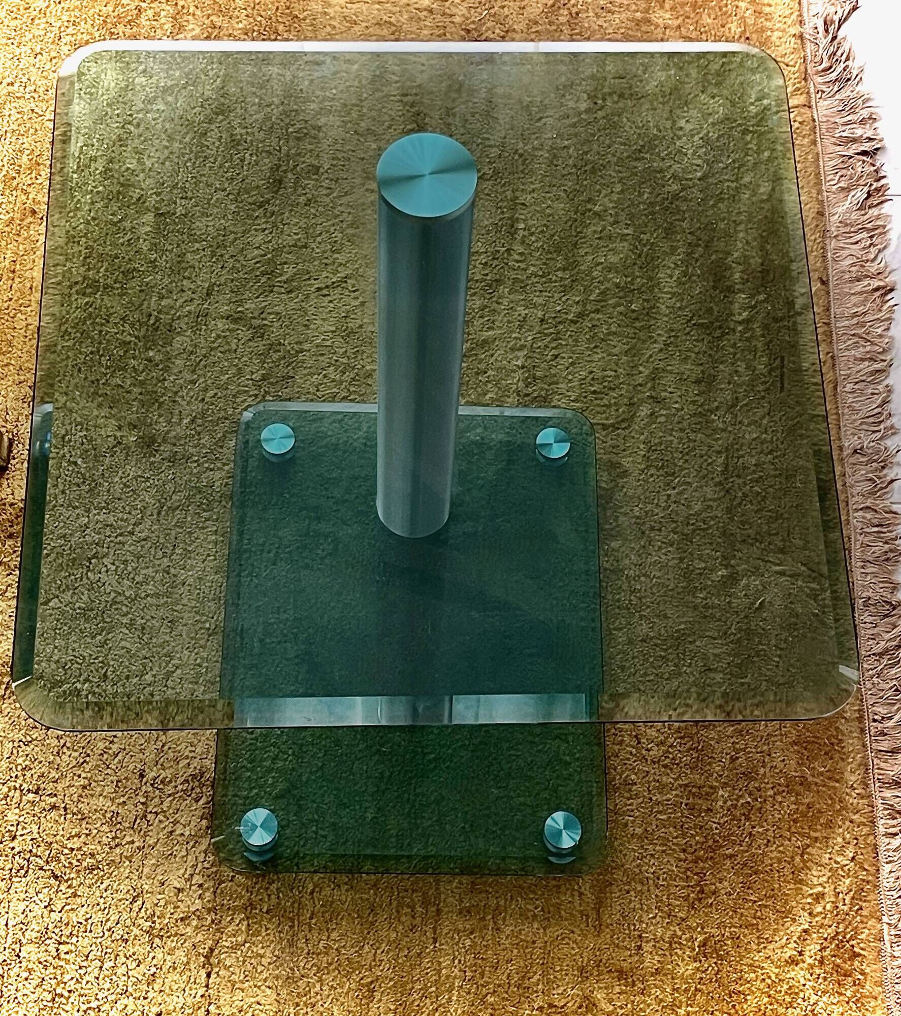Contemporary square side table in glass with a metallic central column.