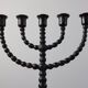 Candelabrum in the shape of a spool, skilfully forged in menorah style.