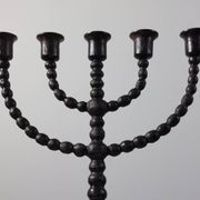 Candelabrum in the shape of a spool, skilfully forged in menorah style.