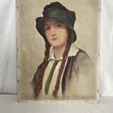 Old portrait of a young woman with braids and a hat, circa 1930