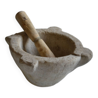 Old white marble mortar and its wooden pestle