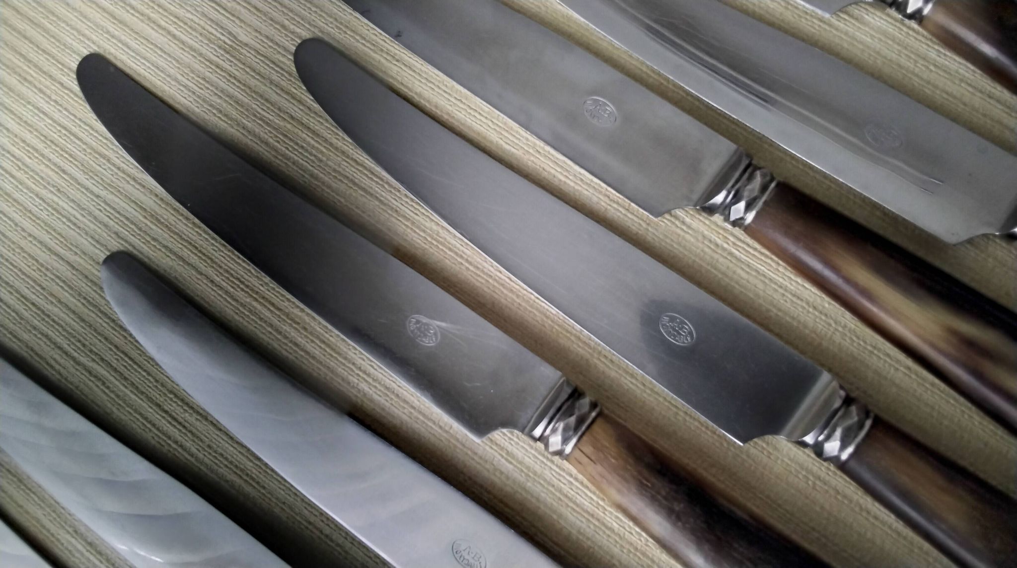 Box of 12 table knives with horn handles, silver-plated metal and stainless steel.