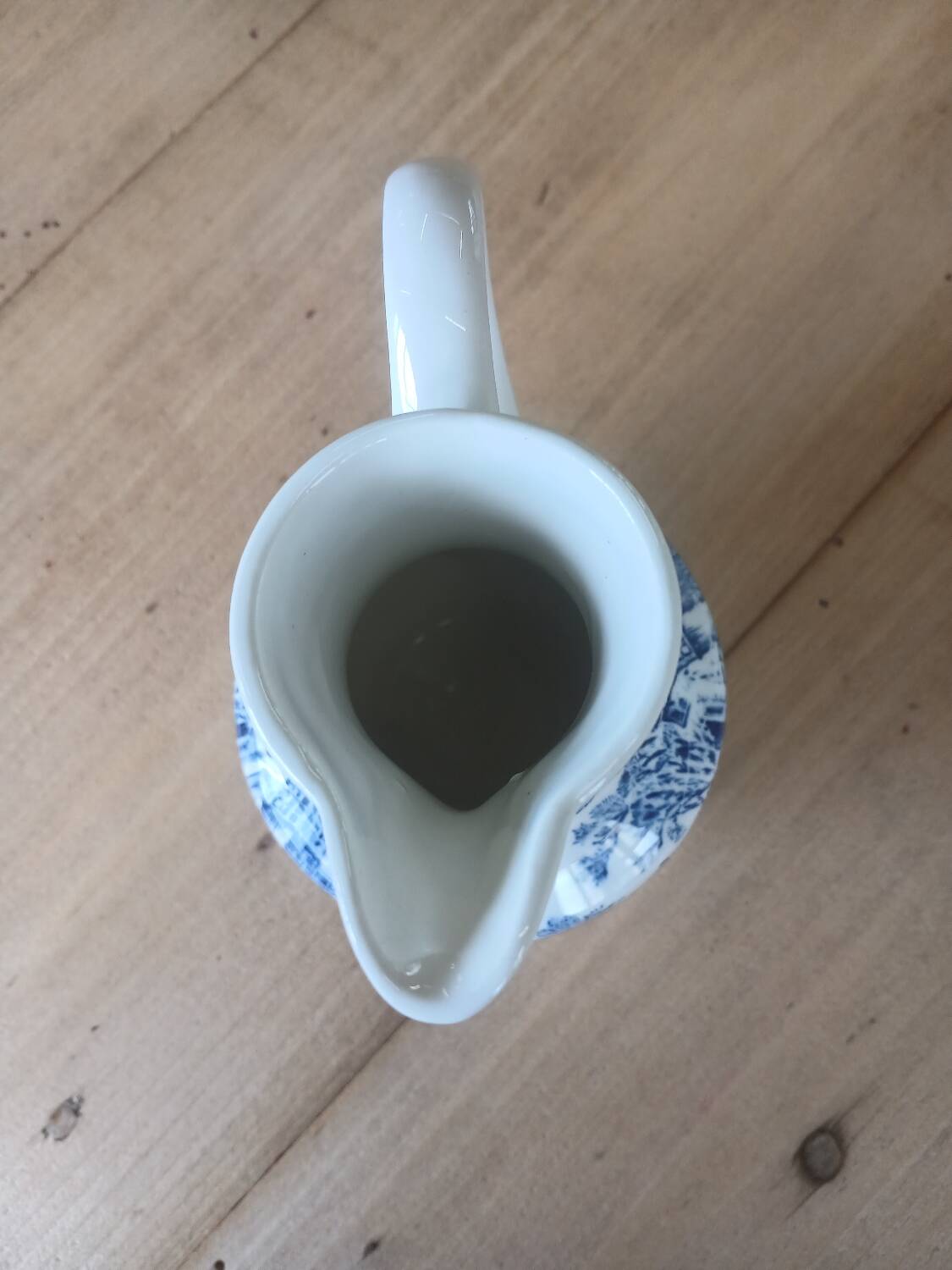 Small old pitcher in iron earth