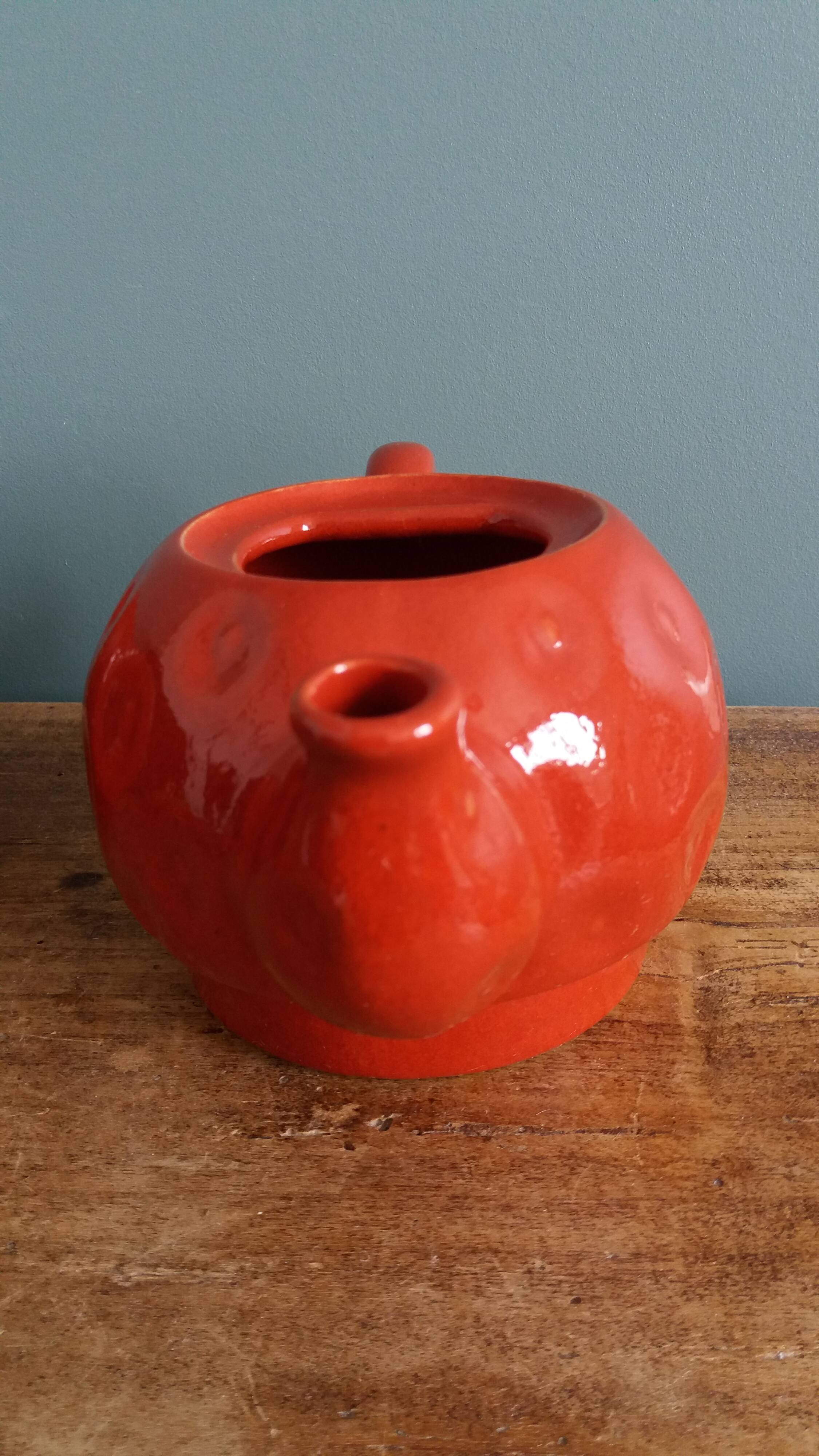Teapot and cup in the shape of a strawberry.