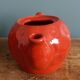Teapot and cup in the shape of a strawberry.
