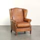 Sheepskin wingback armchair in a light cognac colour in English style