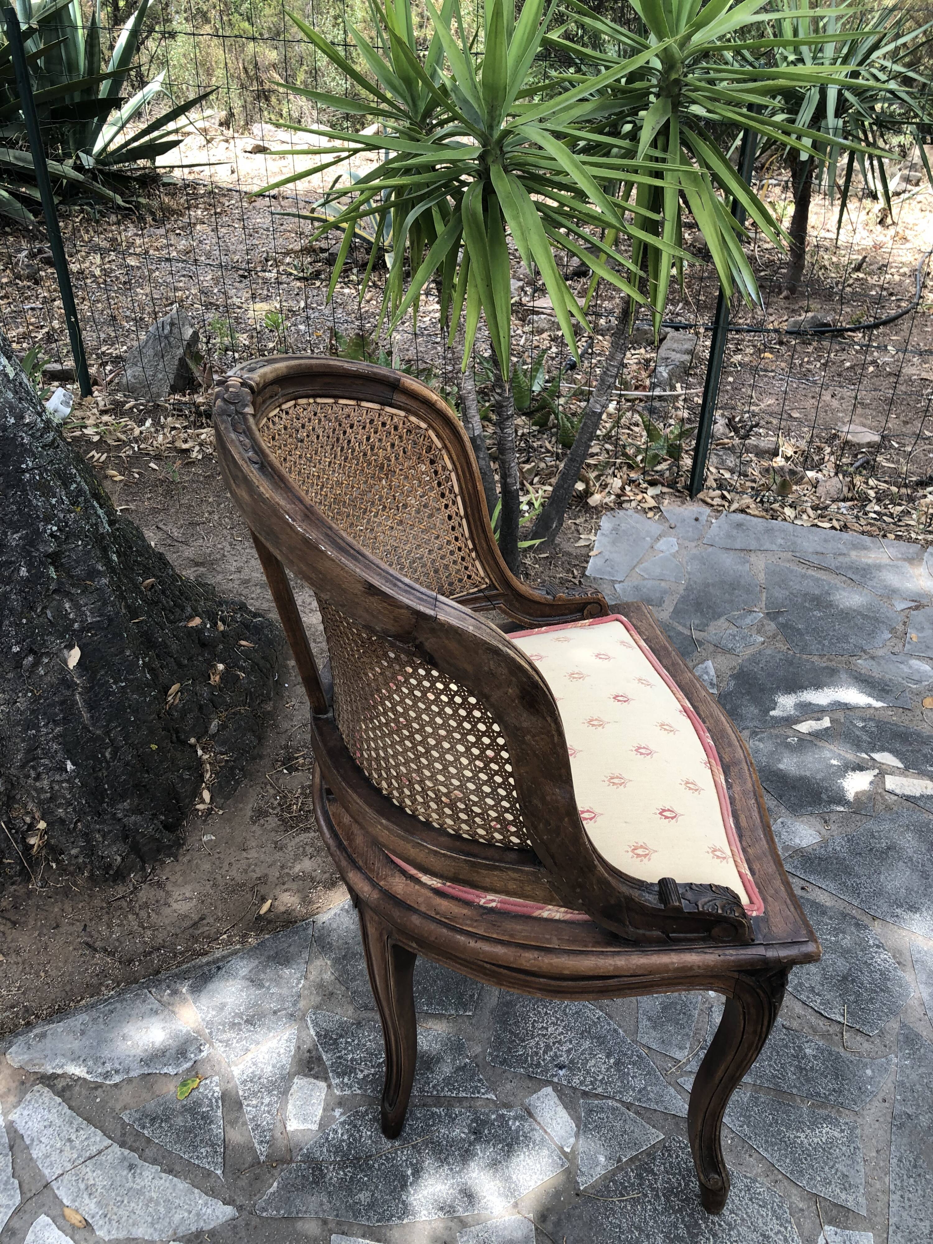 Old wooden armchair and cannage