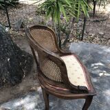 Old wooden armchair and cannage
