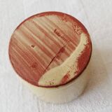 Mustard-colored ceramic cup or glass with green decor