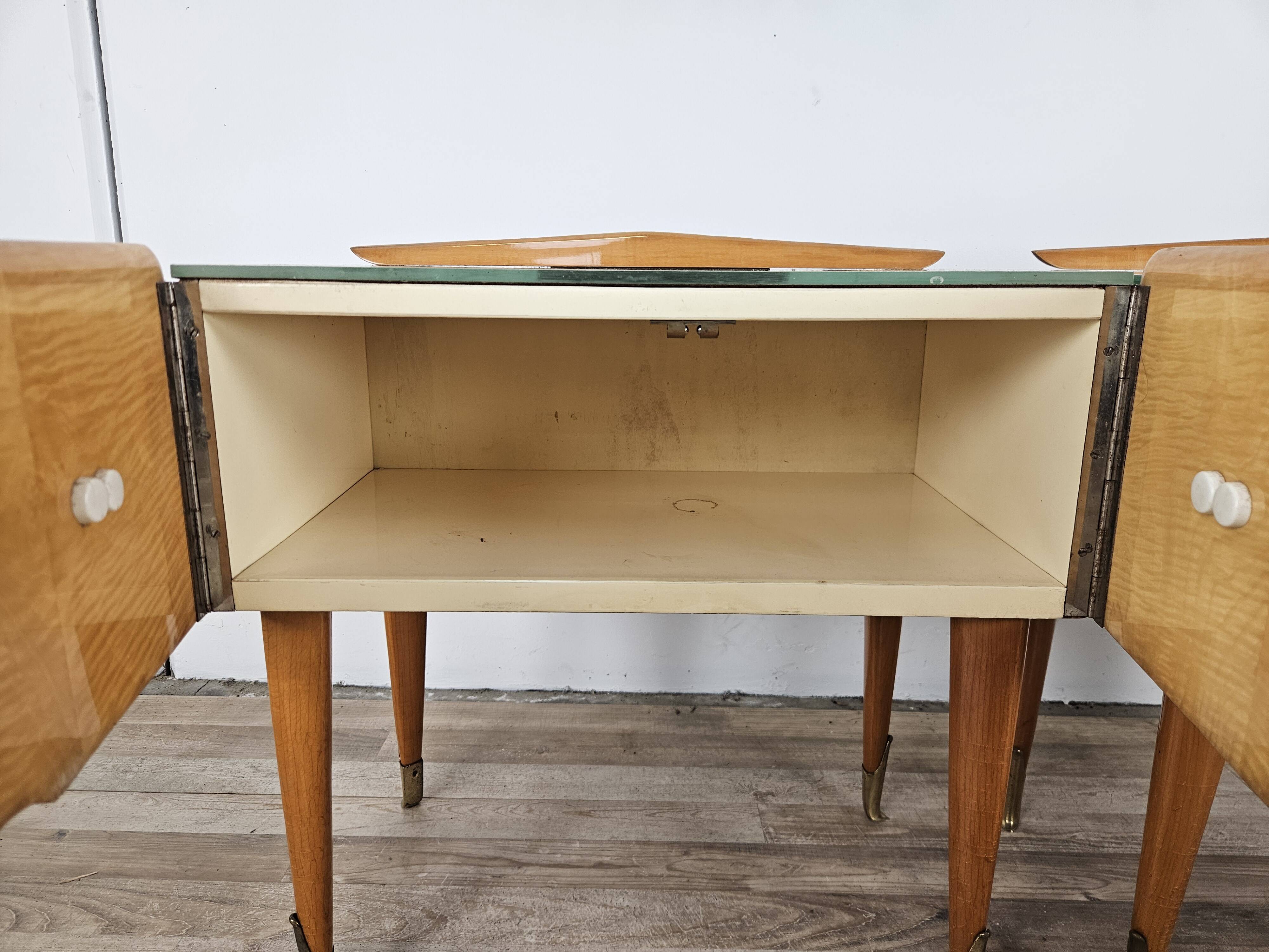 Mid-century nightstands in maple, brass, and glass
