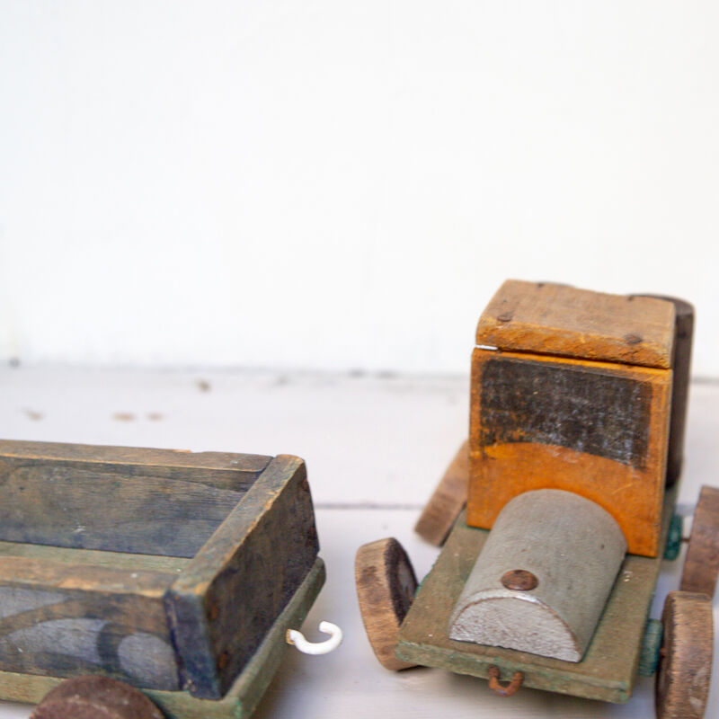 Old wooden train locomotive and toy trailer