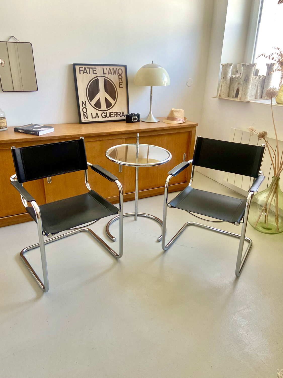 Pair of vintage chrome and black faux leather armchairs
