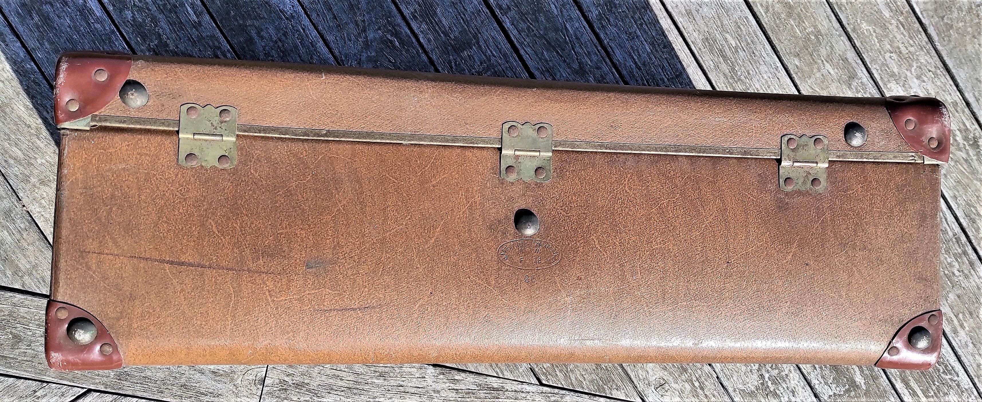 Brown vintage suitcase with CHENEY England brand travel tags