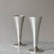 Two silver-coloured lightweight metal flower vases.