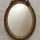 Miroir ovale en bois doré 52 x 35 cm