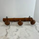 Wooden coat rack with three ball hooks.