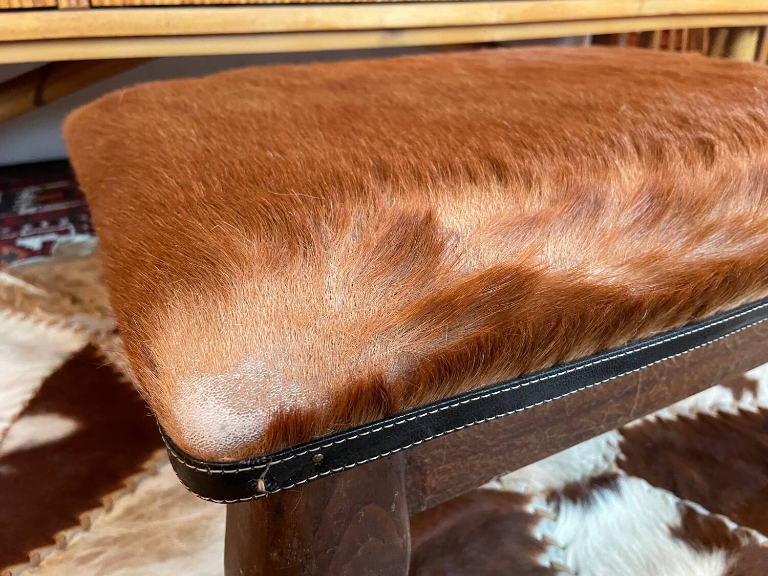 Vintage wooden and goatskin pouf