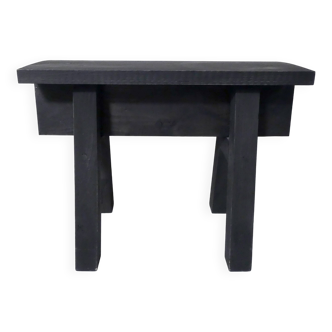 Small blackened wooden step bench