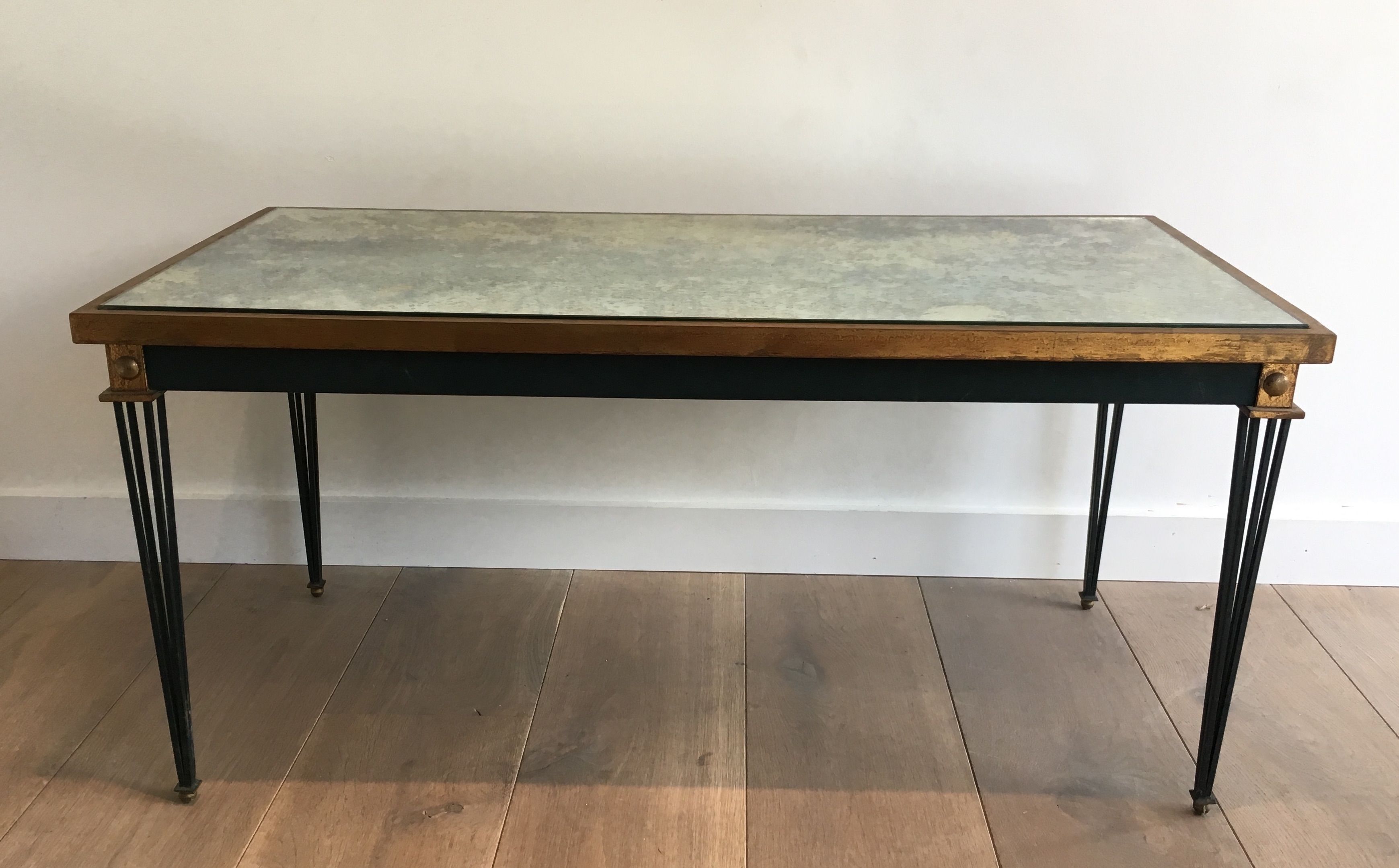 Patinated and gilded steel coffee table in the style of Jacques Quinet.