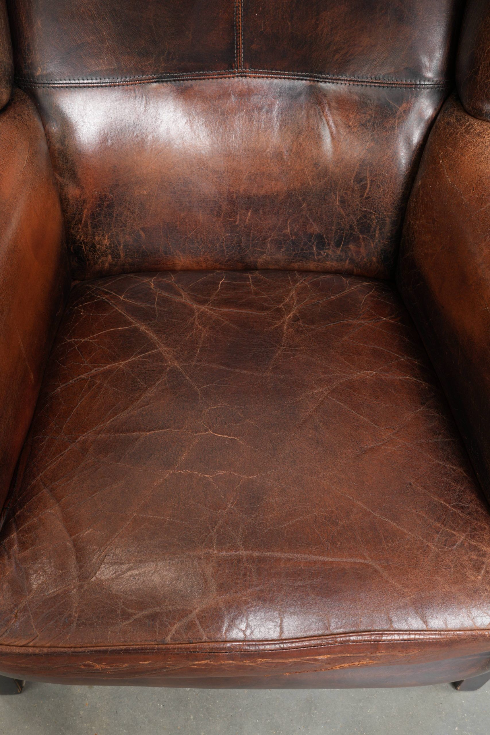 Vintage sheepskin wingback armchair in a deep brown colour finished