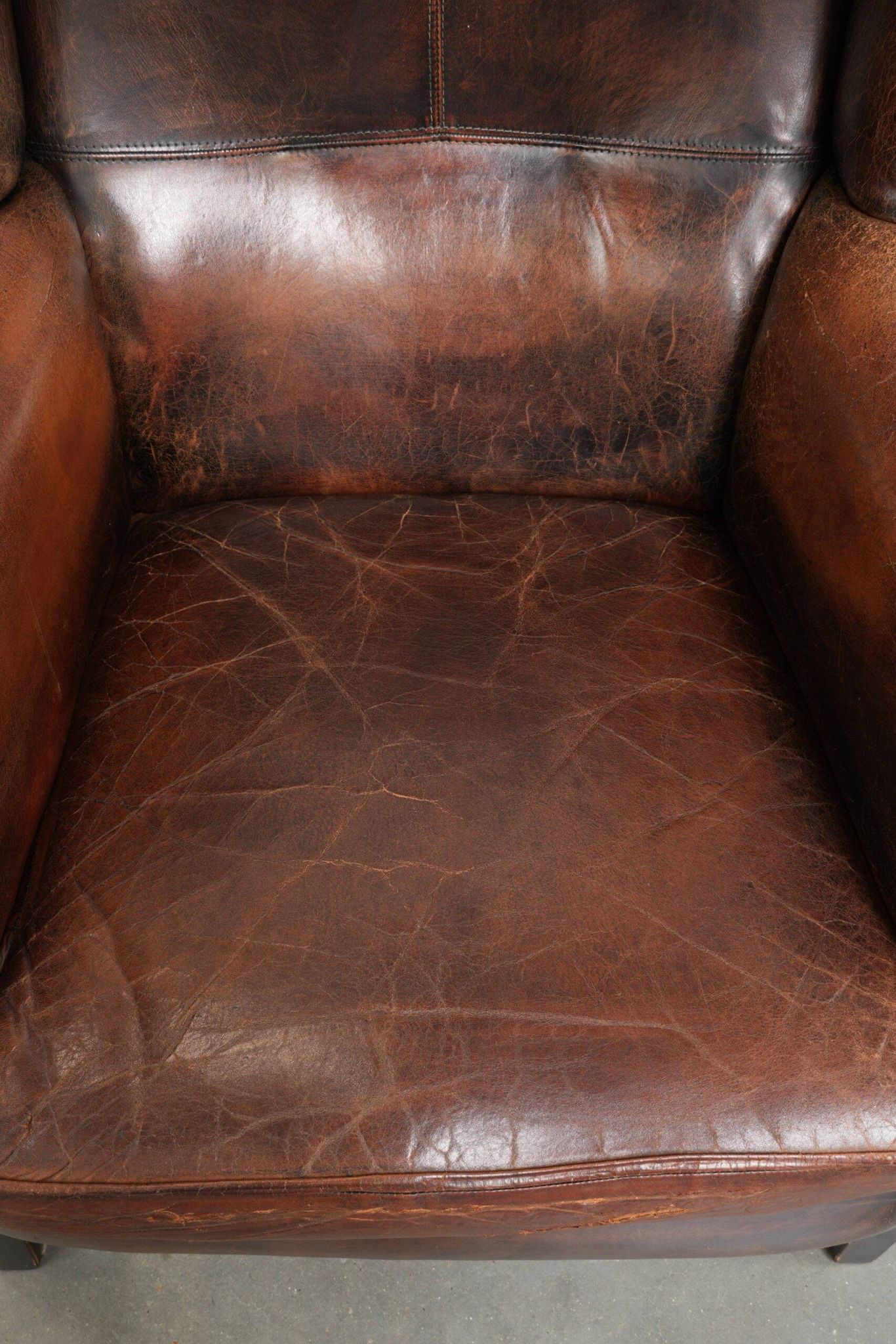 Vintage sheepskin wingback armchair in a deep brown colour finished