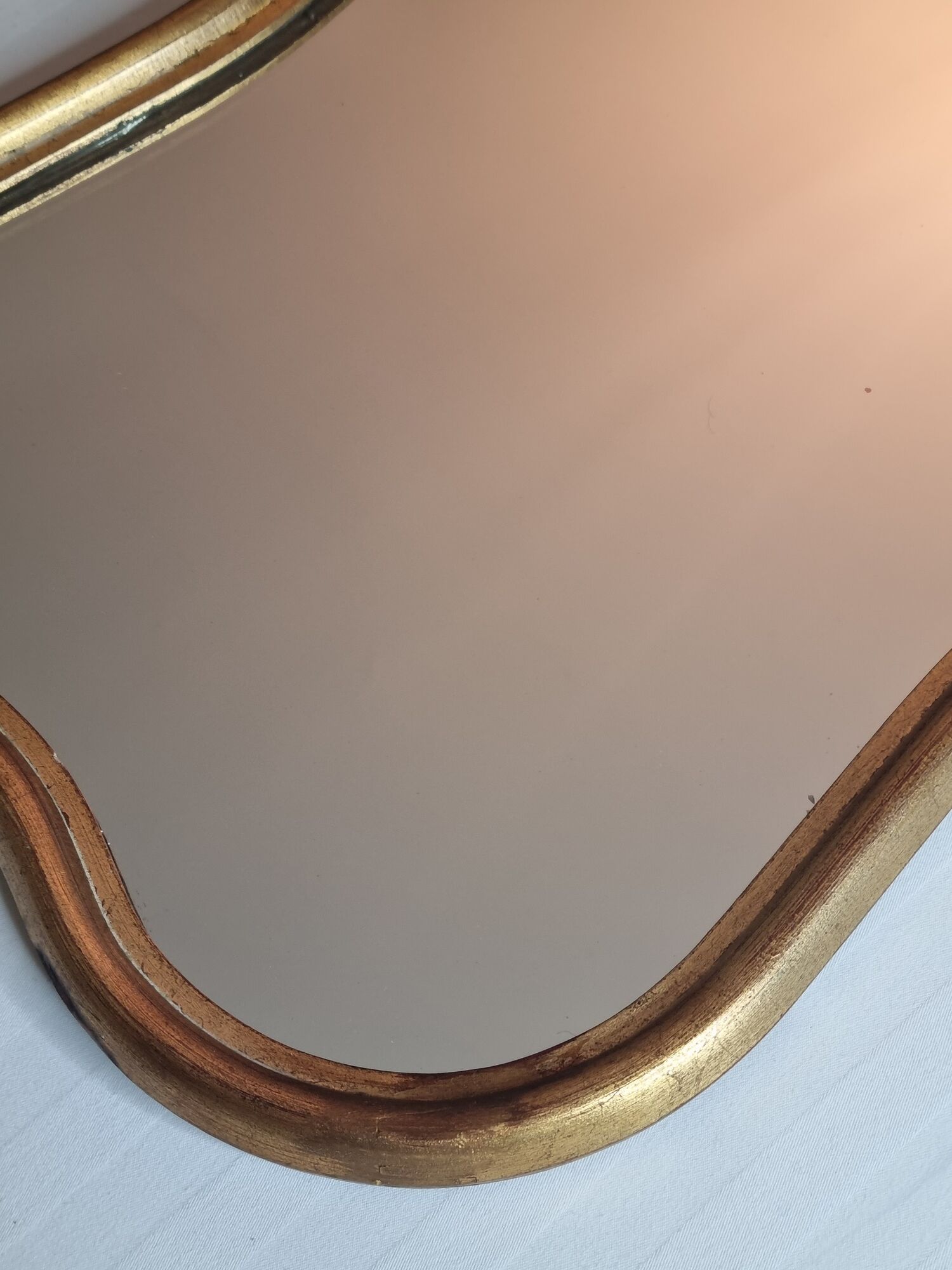 Vintage baroque style mirror, with curved frame in stucco and gilded wood 57 cm
