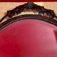Bevelled oval mirror, richly crafted Art Deco wrought iron.