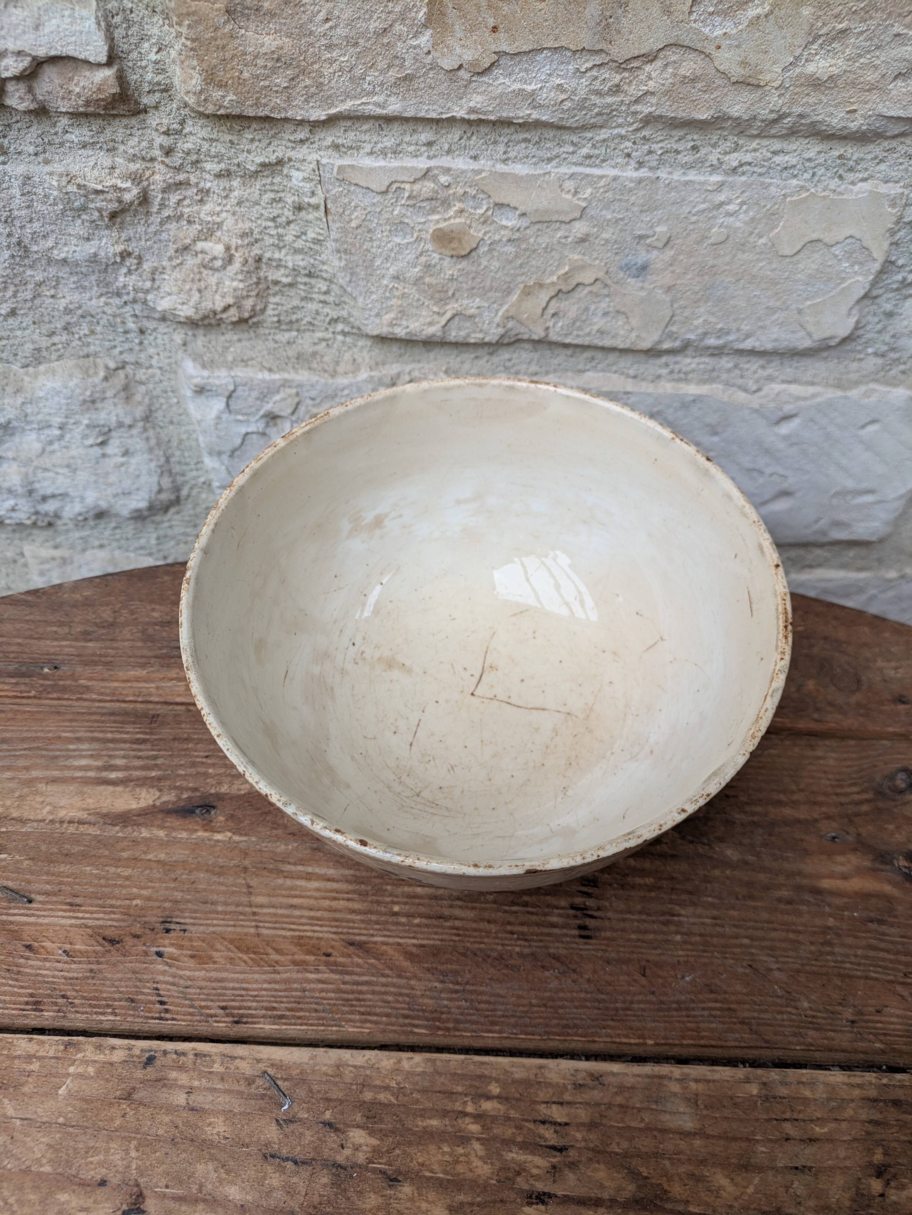 Old opaque porcelain bowl from Gien with a floral decoration.