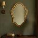 Antique mirror in gilded resin, shaped with curves – neoclassical style