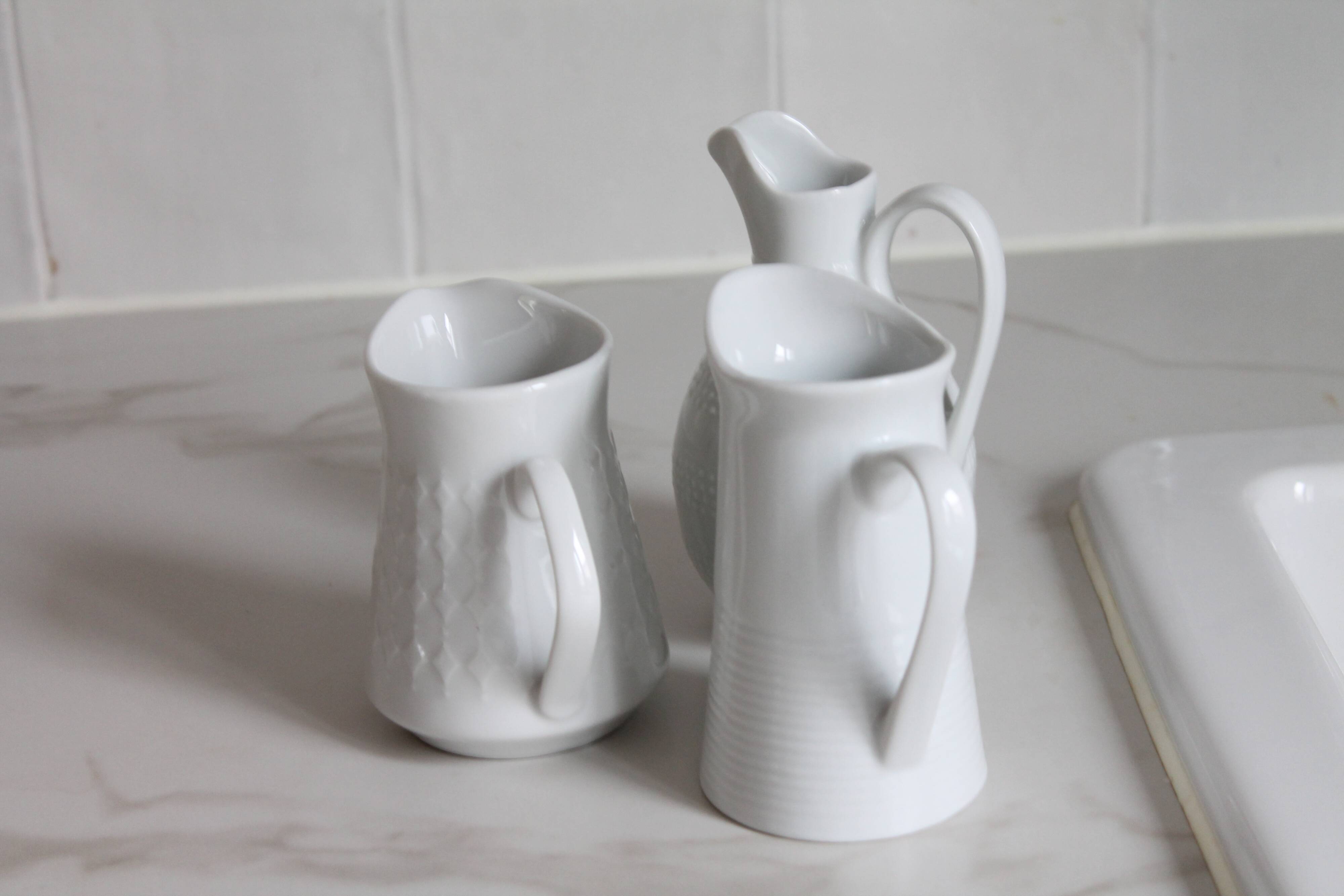 3 old French pitchers in white ceramic