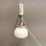 Milky white Holmegaard wall lamp with glass shade and a brass detail on top. Wooden wall bracket