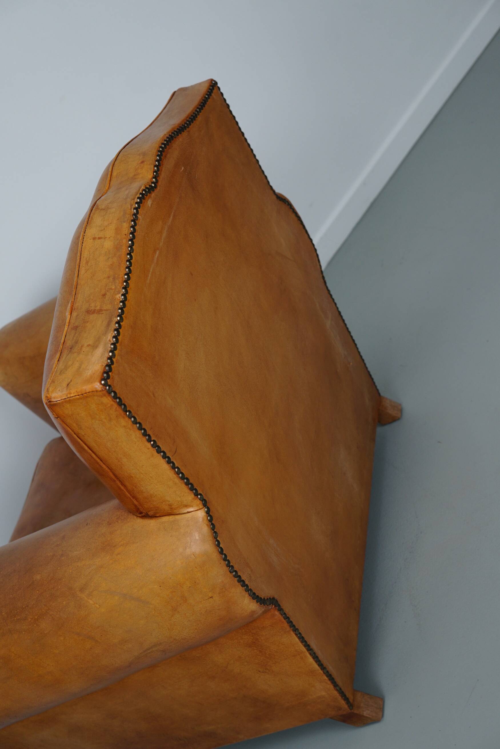 Vintage french moustache back cognac-colored leather club chair
