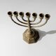 Vintage brass candlestick from the 1950s, seven-branched menorah with ornamental decoration.