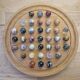Wooden solitaire game with semi-precious stones