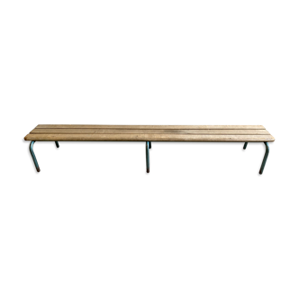 Vintage wood kindergarten bench and tubular structure in long