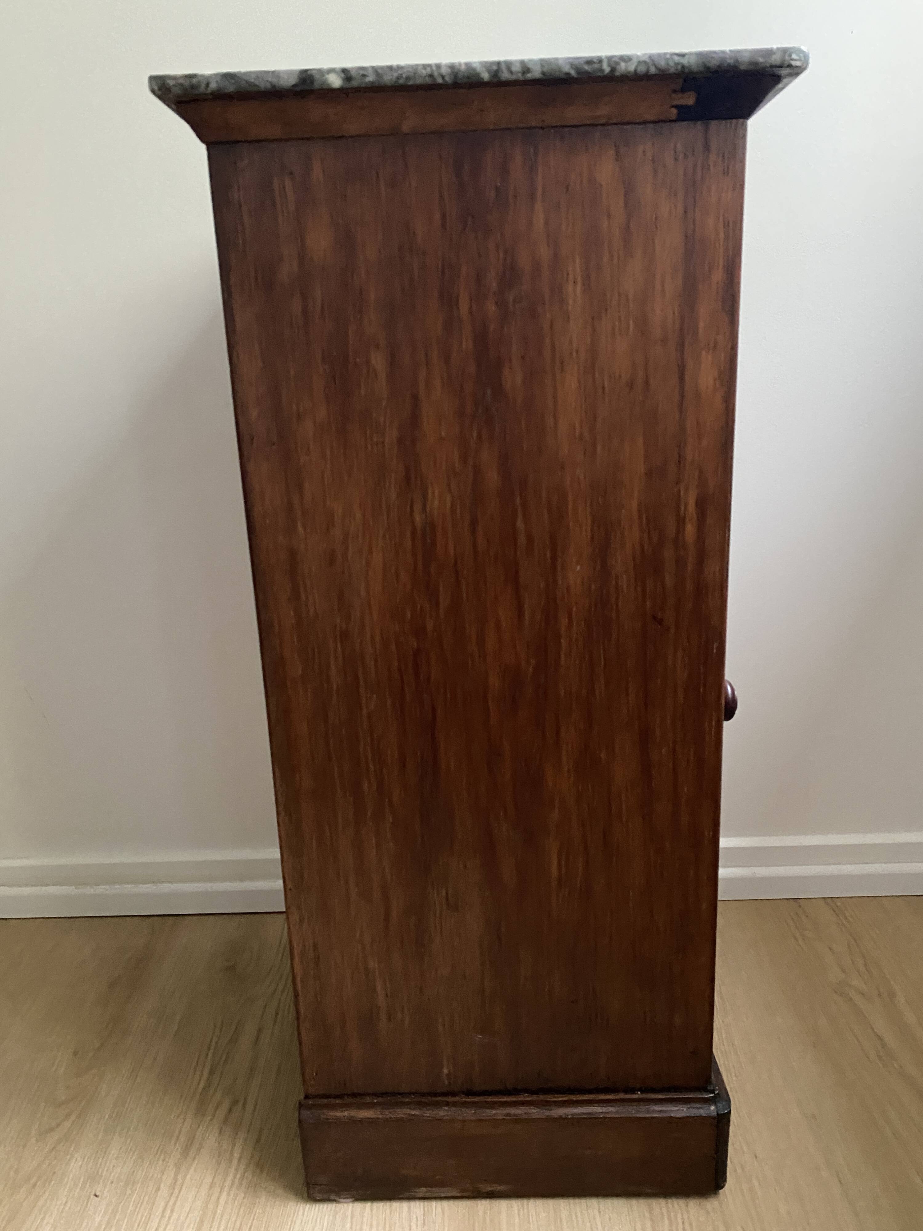 Vintage bedside table in the shape of a wooden column and a gray marble top