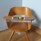 Baumann Baby Coquille children's armchair in bent wood with splayed legs.