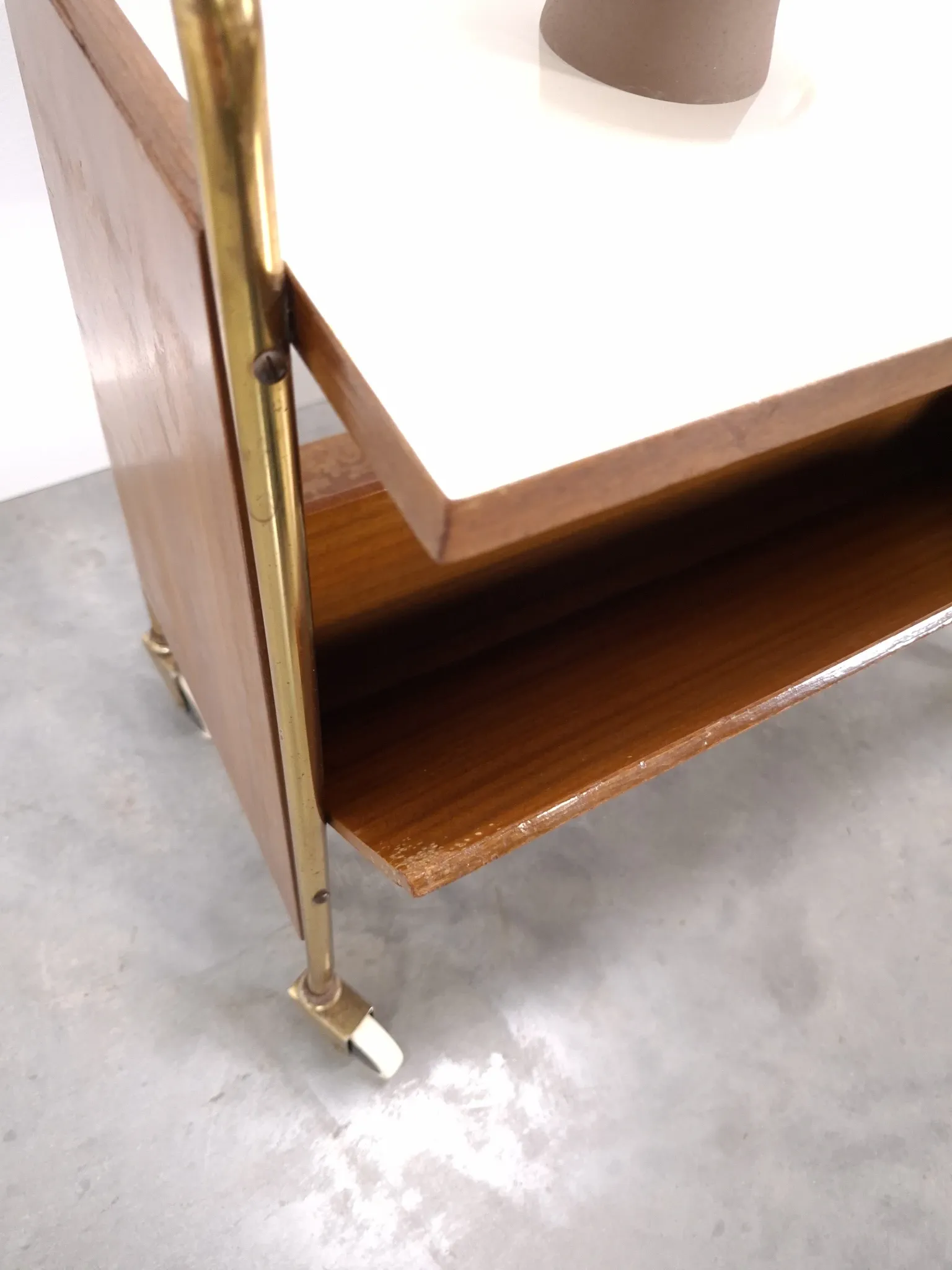 Vintage 1950s side table with a reading basket, formica top, teak wood.