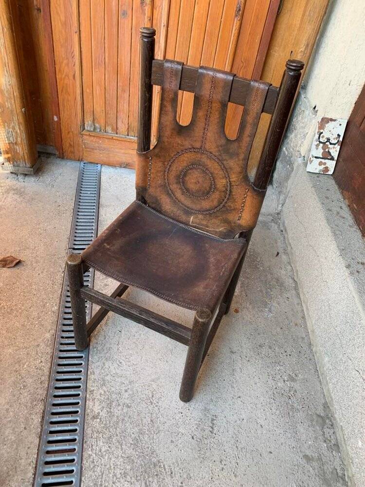 Handcrafted brown leather armchair, dark wood frame, circular pattern - 1970s.