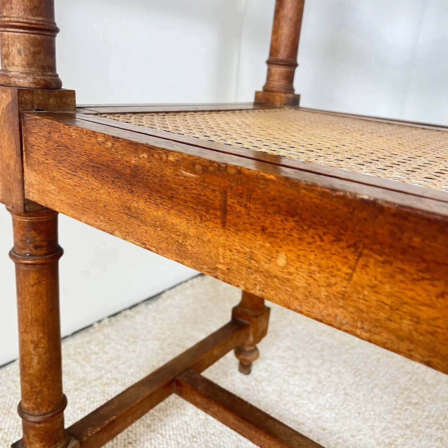 Antique banquette in Louis XIII style, turned wood with caning, late 19th to early 20th century.