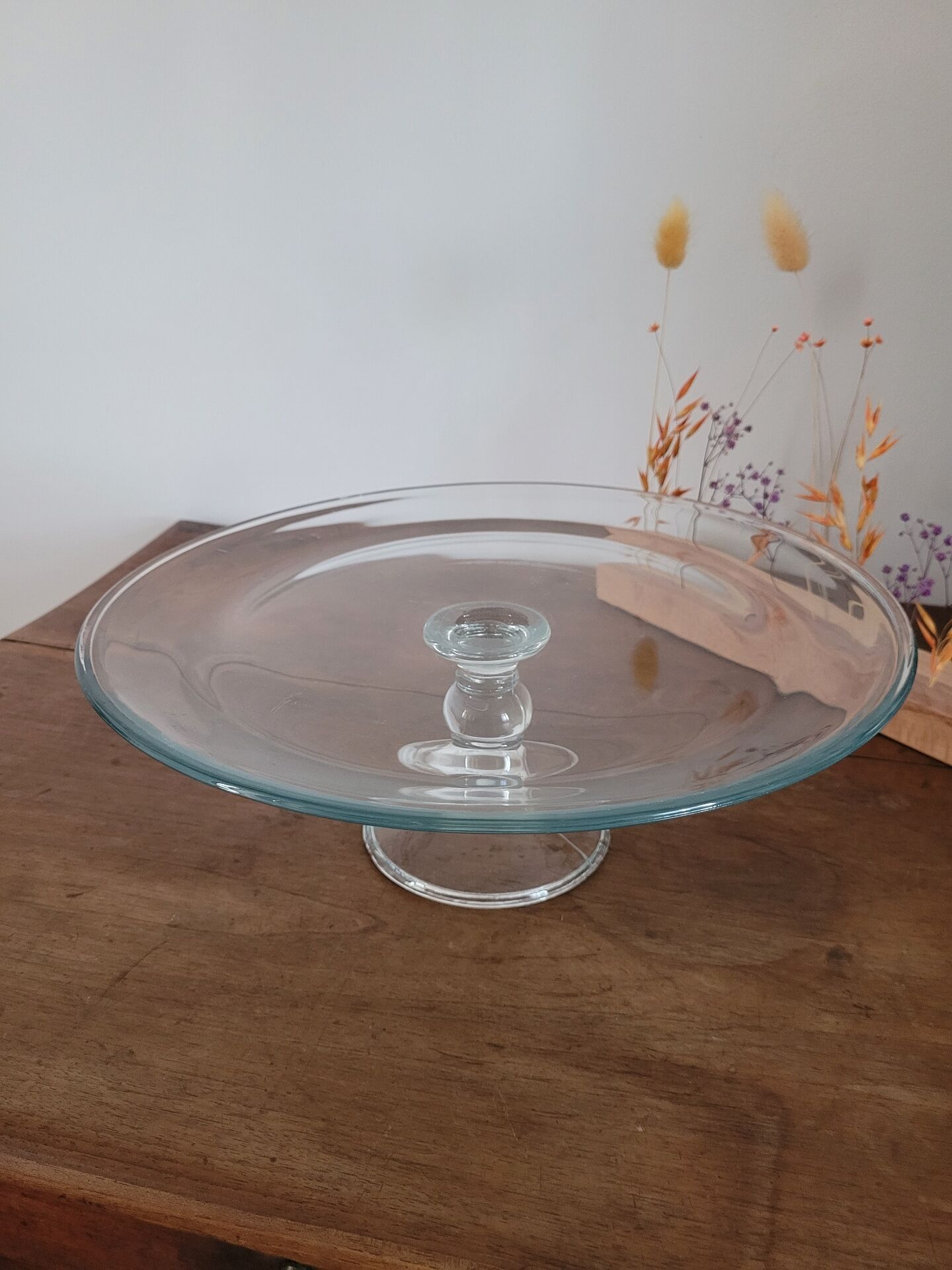 Large glass display plate mounted on a stand.