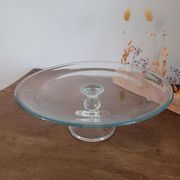 Large glass display plate mounted on a stand.